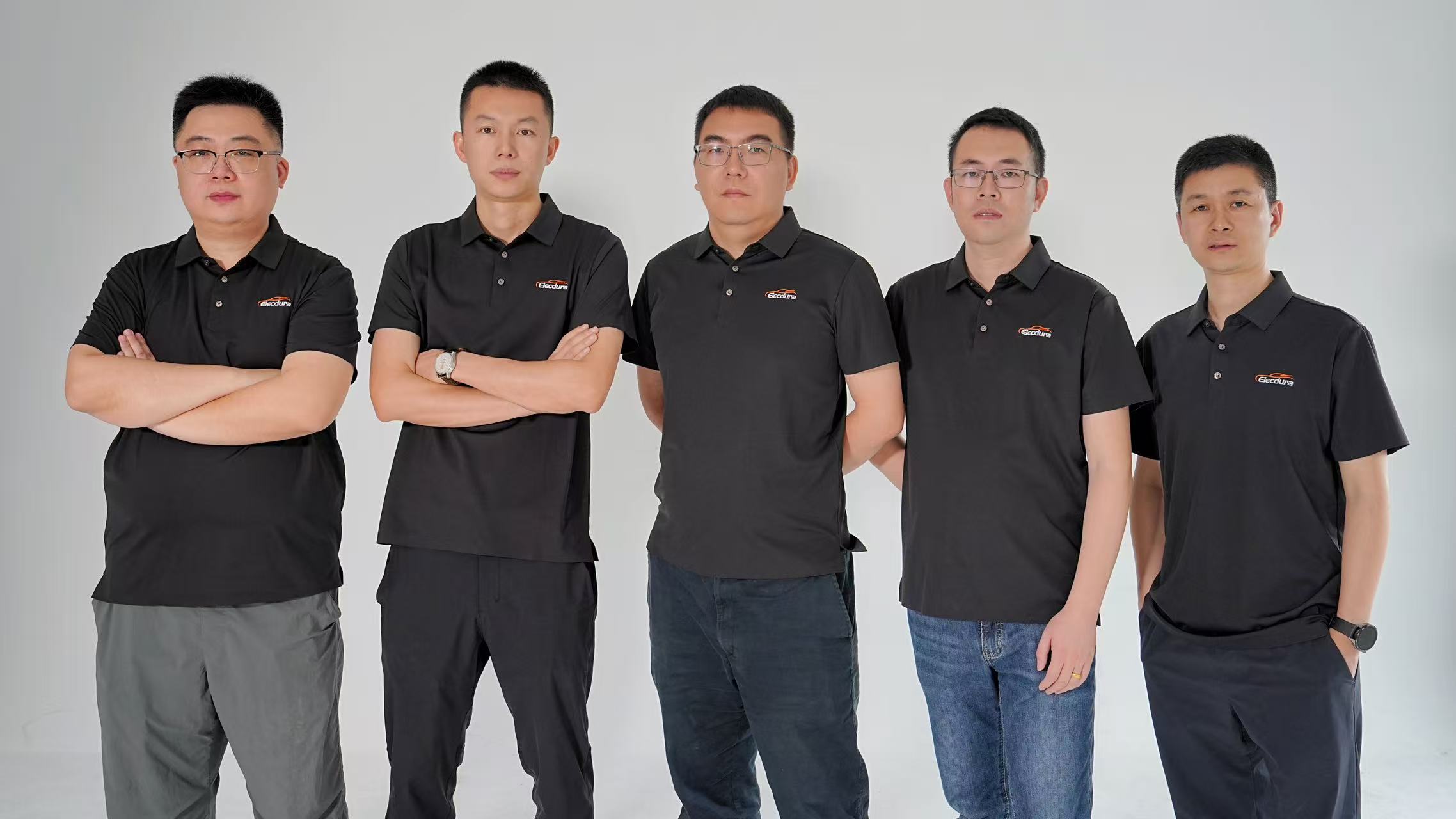 Five people wearing Elecdura-branded shirts in a studio group photograph.