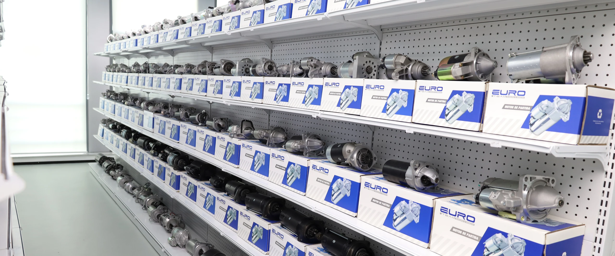 Starter motors arranged on a product display with their original packaging